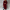 Women's long wine red double-breasted trench coat styled over a dark top and black trousers, carrying a black handbag.